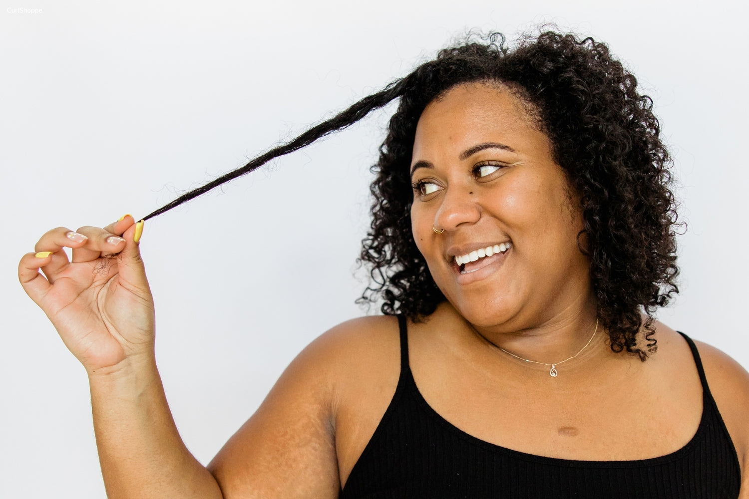 A woman stretching out her curls